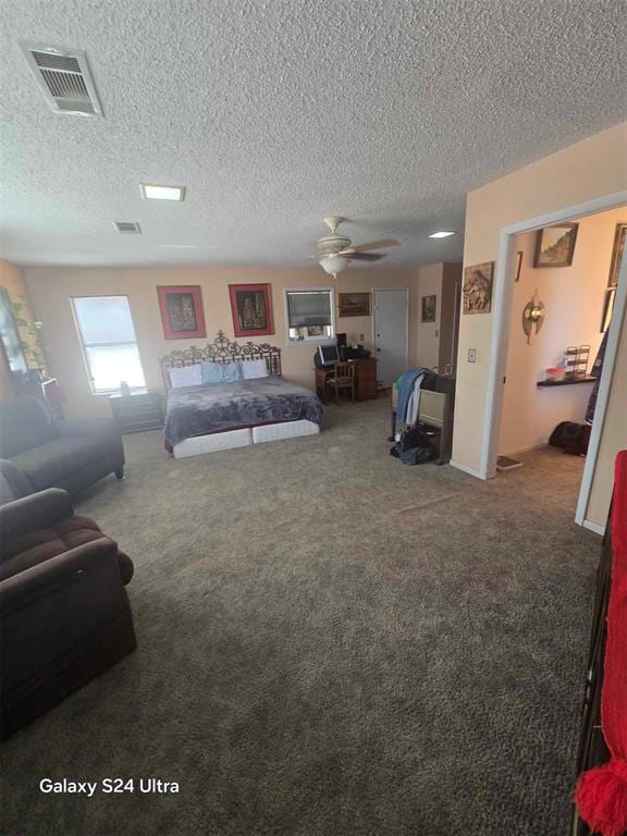 506 E Oklahoma St, Walters, OK 73572 - bedroom with a textured ceiling, visible vents, and carpet
