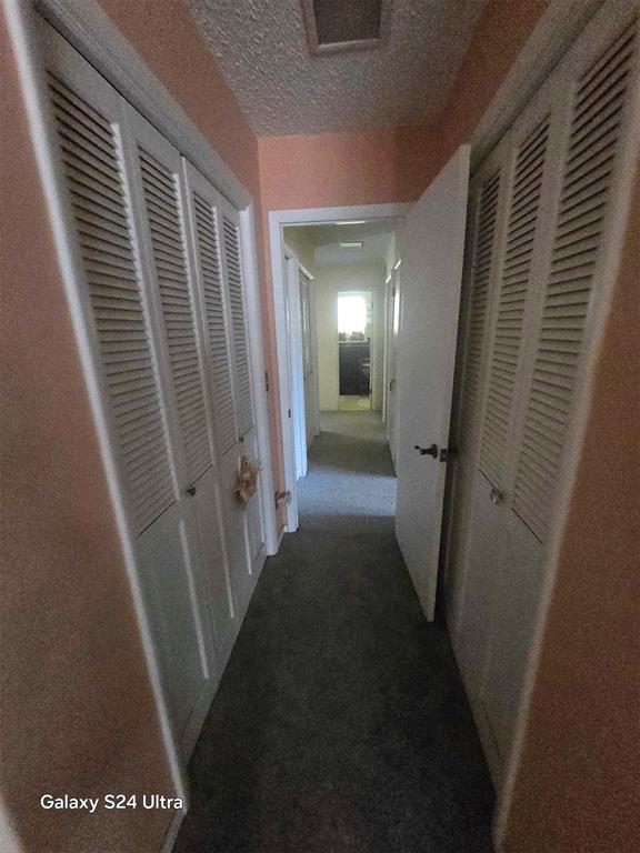 506 E Oklahoma St, Walters, OK 73572 - corridor with visible vents and carpet flooring