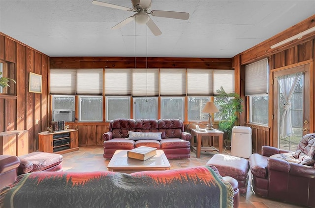 9872 N 2121st Pl, Butler, OK 73625 - living area with wooden walls, a ceiling fan, and cooling unit