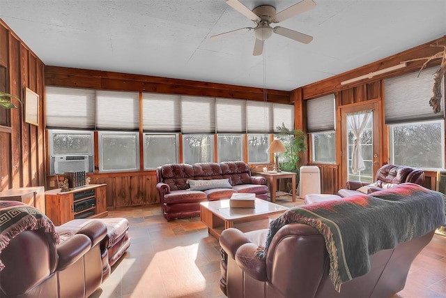 9872 N 2121st Pl, Butler, OK 73625 - living room with wood walls, healthy amount of natural light, and a ceiling fan