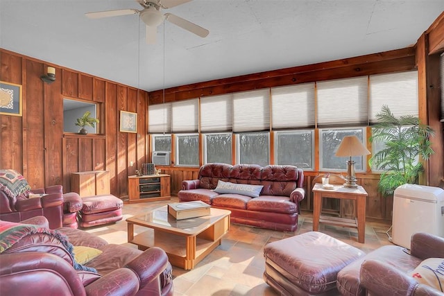 9872 N 2121st Pl, Butler, OK 73625 - living room with wooden walls, a ceiling fan, and stone finish floors