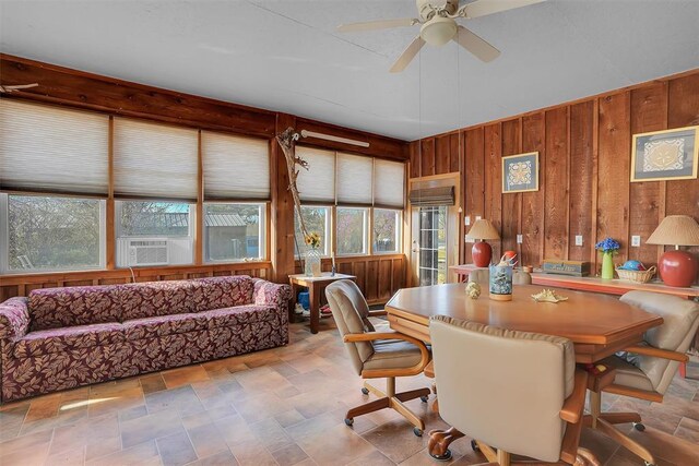 9872 N 2121st Pl, Butler, OK 73625 - dining space featuring wooden walls, a ceiling fan, plenty of natural light, stone finish flooring, and cooling unit