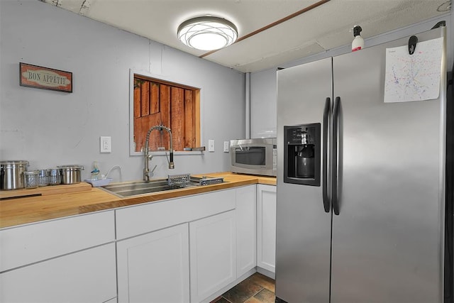 9872 N 2121st Pl, Butler, OK 73625 - kitchen with stainless steel appliances, wood counters, a sink, and white cabinets
