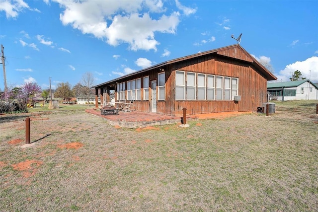 9872 N 2121st Pl, Butler, OK 73625 - back of property featuring a yard, a patio area, and cooling unit