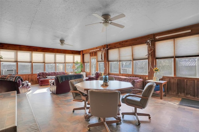 9872 N 2121st Pl, Butler, OK 73625 - sunroom featuring a textured ceiling, wooden walls, stone finish floors, and cooling unit