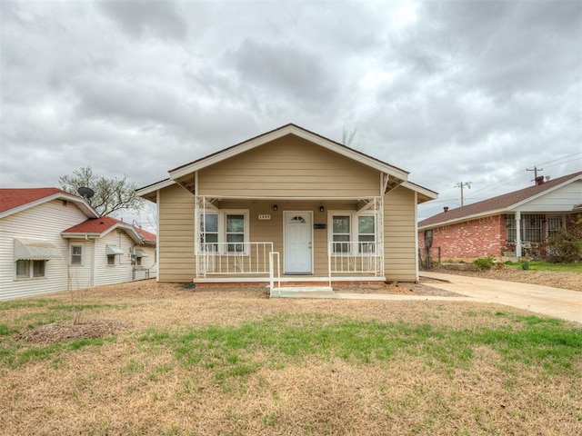 1604 NE Euclid St, Oklahoma City, OK 73117 - bungalow-style home featuring covered porch and a front lawn