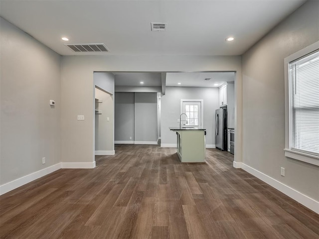 1604 NE Euclid St, Oklahoma City, OK 73117 - unfurnished living room with dark wood-type flooring, baseboards, and visible vents