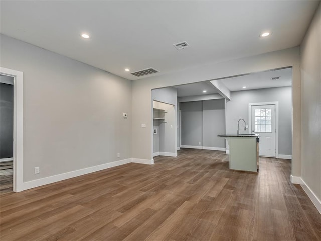 1604 NE Euclid St, Oklahoma City, OK 73117 - unfurnished living room featuring dark wood-type flooring, recessed lighting, visible vents, and baseboards