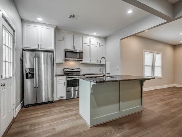 1604 NE Euclid St, Oklahoma City, OK 73117 - kitchen featuring a sink, stainless steel appliances, light wood-style floors, and visible vents