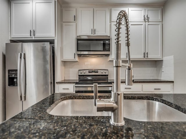 1604 NE Euclid St, Oklahoma City, OK 73117 - kitchen featuring dark stone counters, white cabinets, tasteful backsplash, and stainless steel appliances