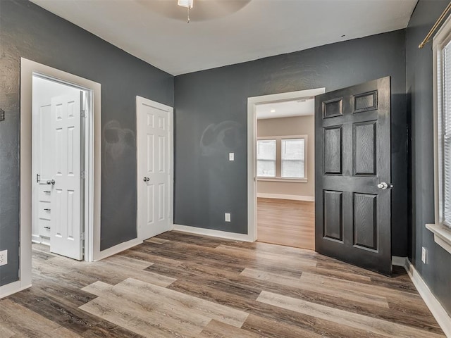 1604 NE Euclid St, Oklahoma City, OK 73117 - unfurnished bedroom featuring wood finished floors, baseboards, and ensuite bathroom