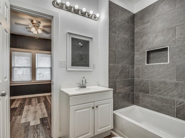 1604 NE Euclid St, Oklahoma City, OK 73117 - full bathroom with a ceiling fan, vanity, wood finished floors, and tub / shower combination