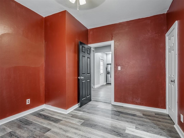 1604 NE Euclid St, Oklahoma City, OK 73117 - unfurnished room featuring baseboards, wood finished floors, a ceiling fan, and a textured wall