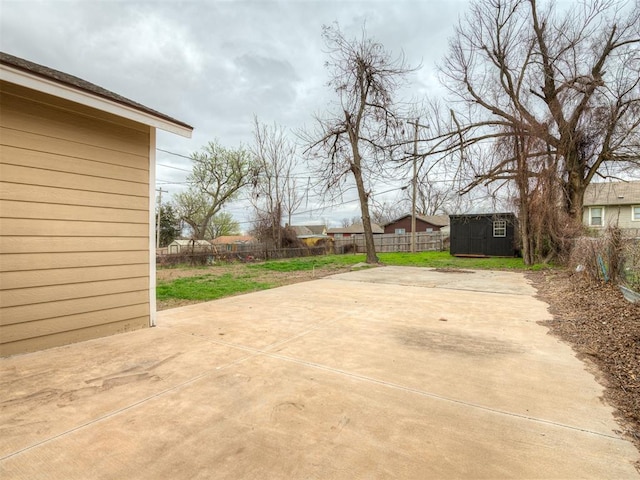 1604 NE Euclid St, Oklahoma City, OK 73117 - view of yard with a patio area, a storage unit, a fenced backyard, and an outdoor structure