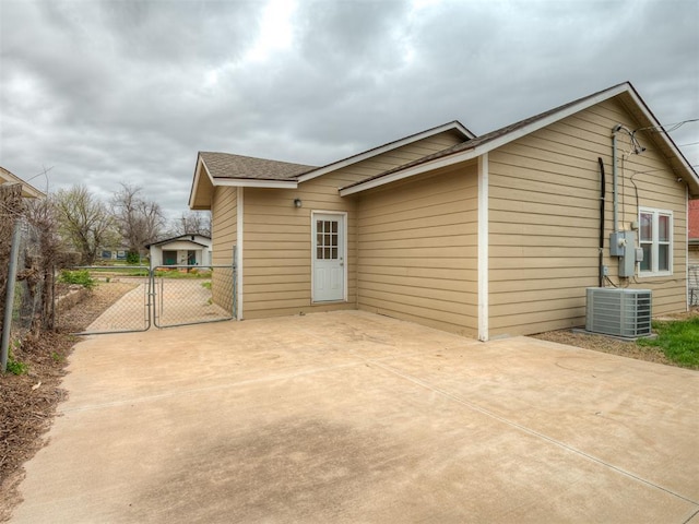 1604 NE Euclid St, Oklahoma City, OK 73117 - rear view of property with a patio, central AC, driveway, and a gate