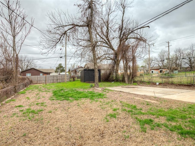 1604 NE Euclid St, Oklahoma City, OK 73117 - view of yard featuring an outbuilding, a fenced backyard, and a shed