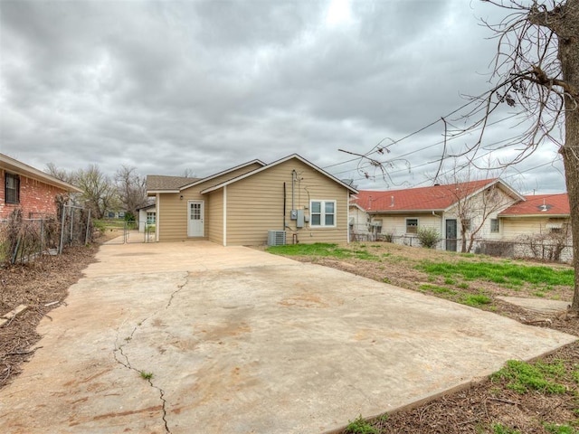 1604 NE Euclid St, Oklahoma City, OK 73117 - back of house featuring concrete driveway, fence, and central AC