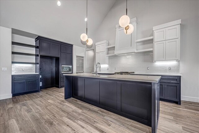4201 Emery Dr, Edmond, OK 73034 - kitchen with open shelves, a sink, high vaulted ceiling, light countertops, and backsplash