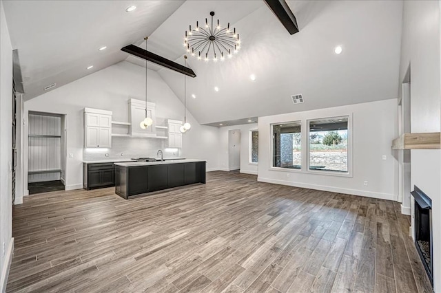 4201 Emery Dr, Edmond, OK 73034 - kitchen featuring open floor plan, a chandelier, high vaulted ceiling, light countertops, and baseboards