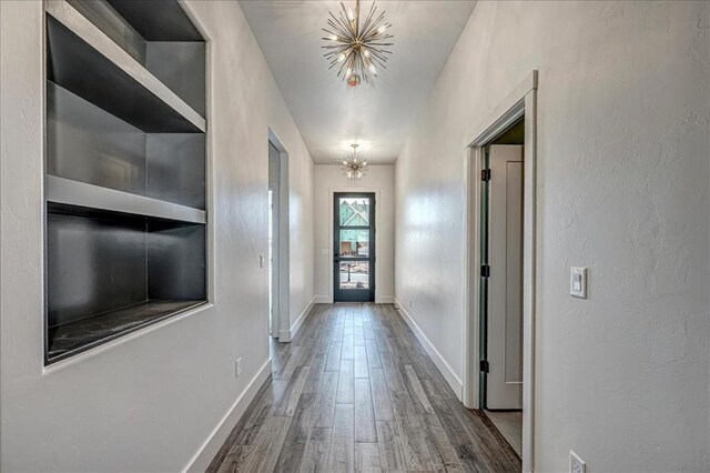 4201 Emery Dr, Edmond, OK 73034 - doorway with wood finished floors, a chandelier, and baseboards