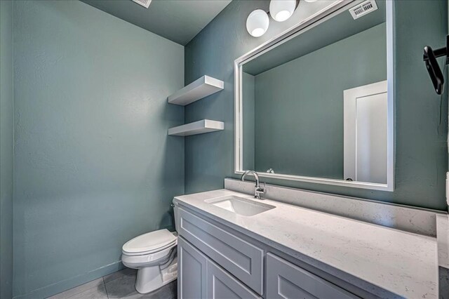 4201 Emery Dr, Edmond, OK 73034 - half bath featuring toilet, vanity, and baseboards