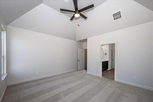 4201 Emery Dr, Edmond, OK 73034 - unfurnished bedroom with light carpet, high vaulted ceiling, baseboards, and ensuite bath