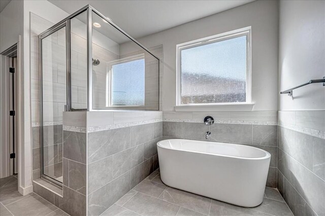4201 Emery Dr, Edmond, OK 73034 - full bath with a shower stall, a freestanding bath, tile patterned floors, tile walls, and wainscoting