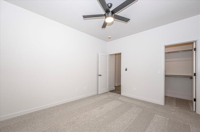 4201 Emery Dr, Edmond, OK 73034 - unfurnished bedroom featuring a walk in closet, carpet floors, baseboards, a closet, and ceiling fan