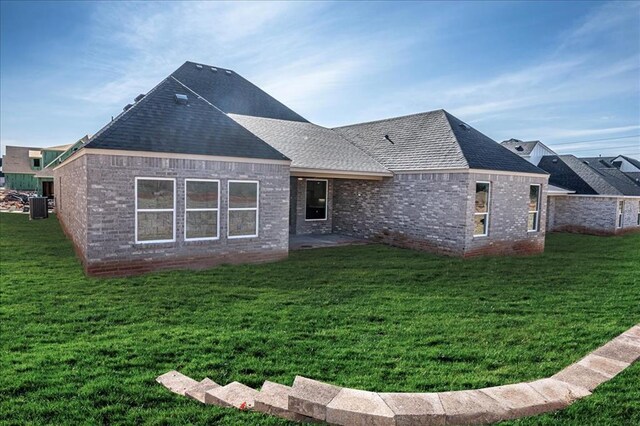 4201 Emery Dr, Edmond, OK 73034 - back of house with a yard, central AC unit, a shingled roof, and a patio area