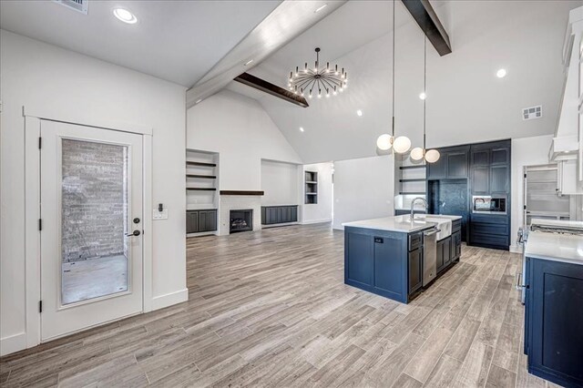 4201 Emery Dr, Edmond, OK 73034 - kitchen with beamed ceiling, a chandelier, light countertops, high vaulted ceiling, and pendant lighting
