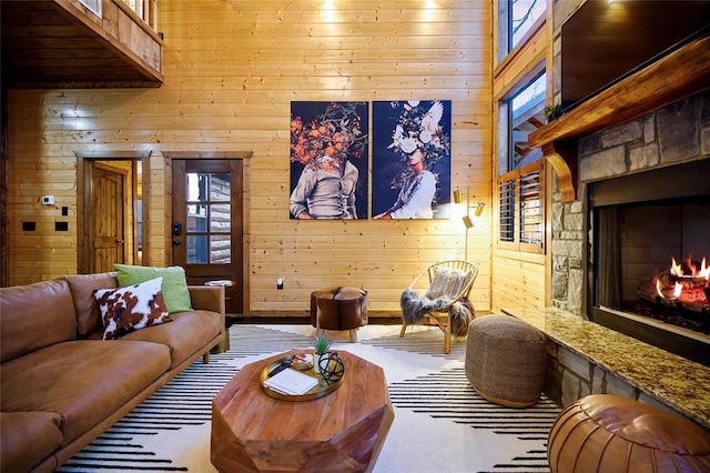 living area featuring wood walls and a towering ceiling