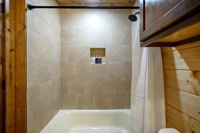 bathroom with shower / bath combo with shower curtain