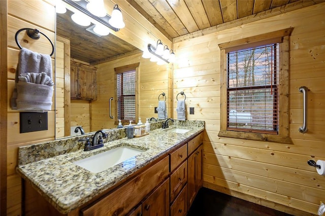 full bathroom featuring wooden ceiling, wooden walls, and double vanity