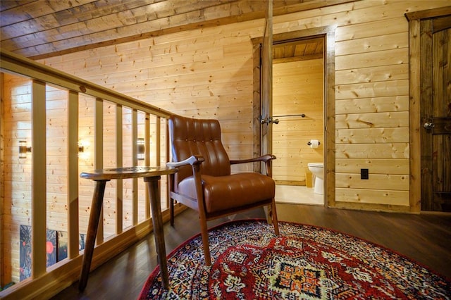 sitting room featuring wood walls and wood finished floors