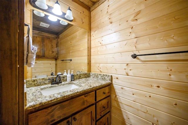 bathroom with wooden walls and vanity