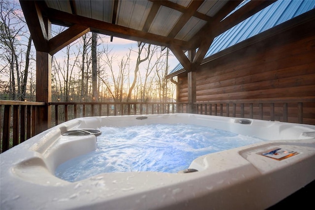 view of swimming pool with a hot tub