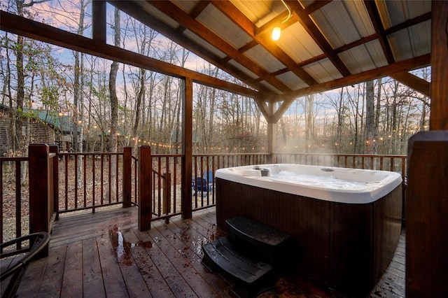 wooden deck with a hot tub