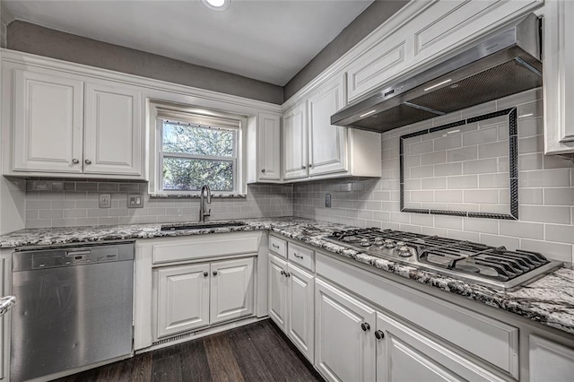10900 Willow Grove Rd, Oklahoma City, OK 73120 - kitchen with appliances with stainless steel finishes, a sink, exhaust hood, white cabinetry, and decorative backsplash