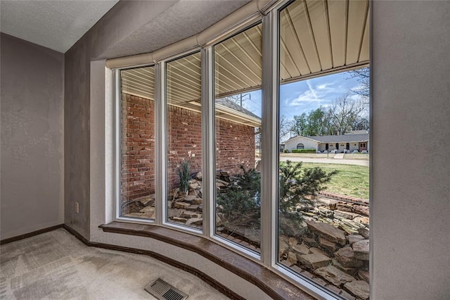 10900 Willow Grove Rd, Oklahoma City, OK 73120 - doorway to outside featuring carpet floors and baseboards