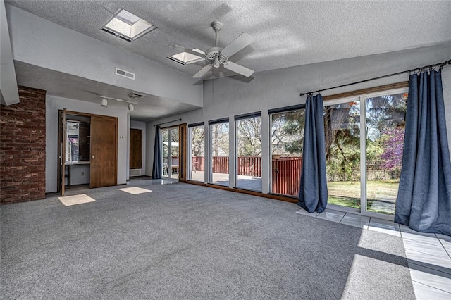 10900 Willow Grove Rd, Oklahoma City, OK 73120 - unfurnished living room featuring a textured ceiling, a ceiling fan, plenty of natural light, and carpet flooring