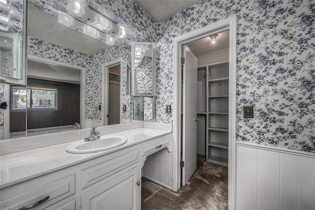 10900 Willow Grove Rd, Oklahoma City, OK 73120 - bathroom with wallpapered walls, a textured ceiling, and vanity
