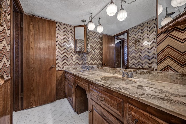 10900 Willow Grove Rd, Oklahoma City, OK 73120 - bathroom with wallpapered walls, double vanity, a textured ceiling, and tile patterned floors
