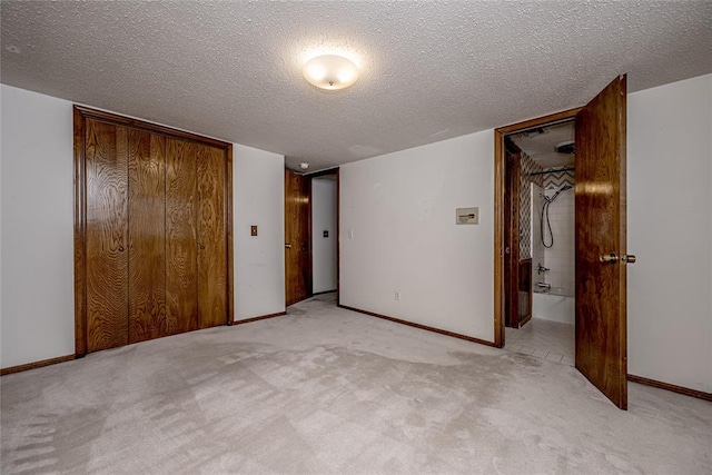 10900 Willow Grove Rd, Oklahoma City, OK 73120 - unfurnished bedroom with a textured ceiling, light carpet, and baseboards