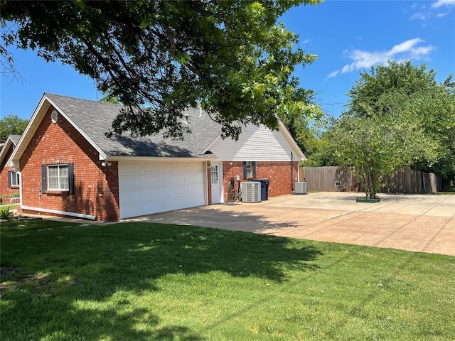 10900 Willow Grove Rd, Oklahoma City, OK 73120 - view of side of property featuring brick siding, an attached garage, roof with shingles, and concrete driveway