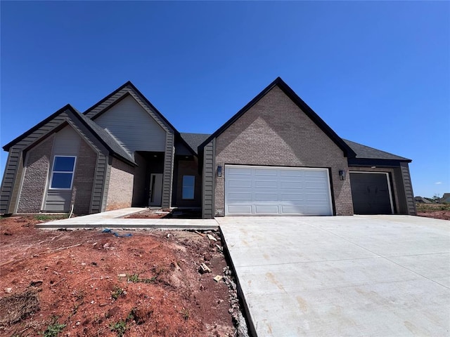single story home with an attached garage, driveway, and brick siding