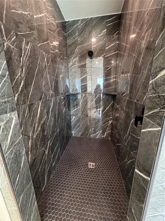full bath with a tile shower