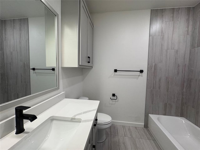 full bath featuring vanity, baseboards, and toilet