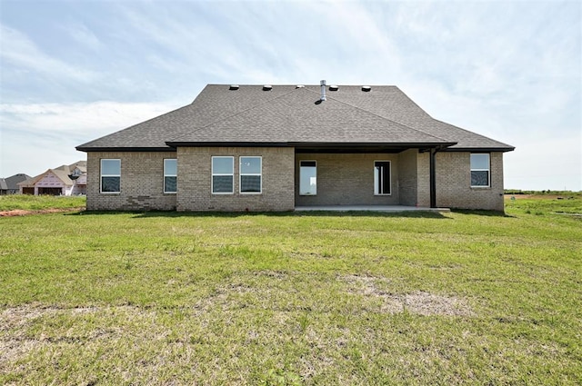 9321 NW 147th Ter, Yukon, OK 73099 - back of property with a shingled roof, brick siding, and a lawn