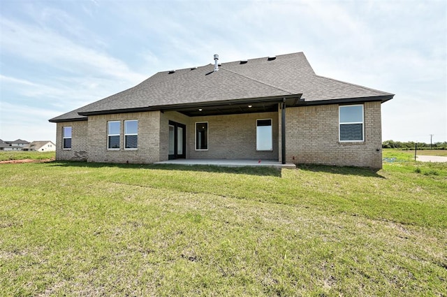 9321 NW 147th Ter, Yukon, OK 73099 - rear view of property featuring roof with shingles, a patio, brick siding, and a lawn