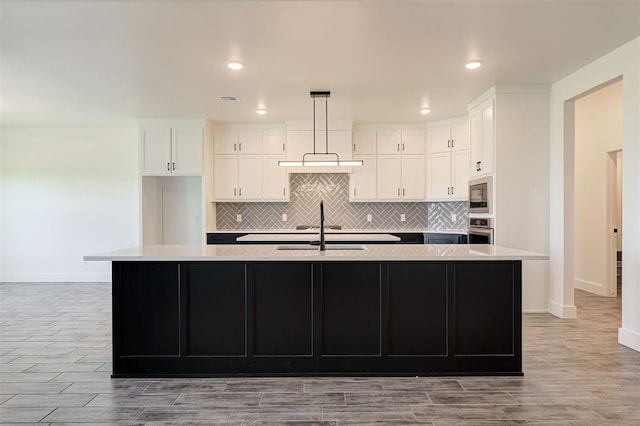 9321 NW 147th Ter, Yukon, OK 73099 - kitchen with appliances with stainless steel finishes, white cabinetry, light wood-style flooring, light countertops, and recessed lighting